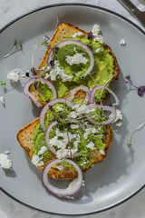 avocado toast on plate in hard light