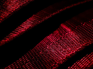 Close-up of red straps featuring a textured, woven pattern. 