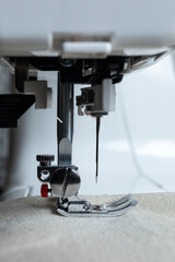 a side view of a sewing machine presser foot on fabric