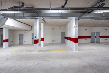 Underground parking garage with storage units and ventilation system