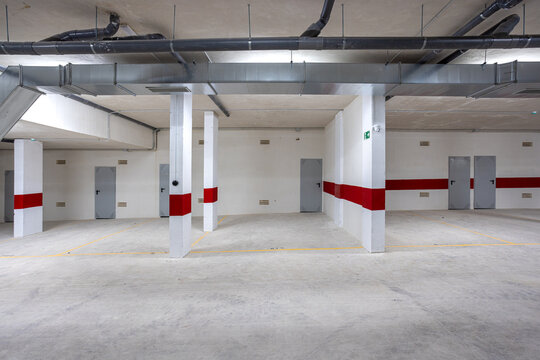 Underground parking garage with storage units and ventilation system