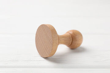 One wooden stamp on white table, closeup
