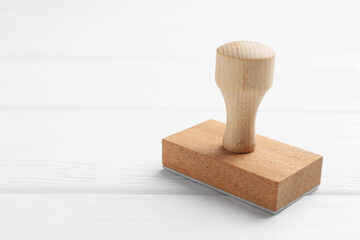 One wooden stamp on white table, closeup. Space for text