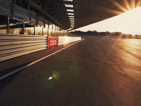 Golden Hour Backlit Pit Lane with Sun Flare, Racing Background