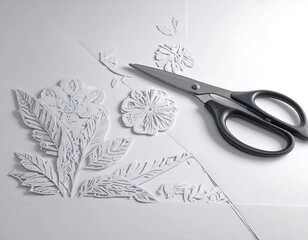 Elegant paper cutting artwork featuring scissors and intricate floral designs in white