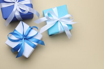 Beautiful gift boxes on beige background, flat lay