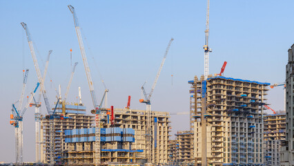Construction site with cranes and rising high rise buildings shaping a growing city skyline. Urban development and steady progress shown in a dynamic view of modern architecture