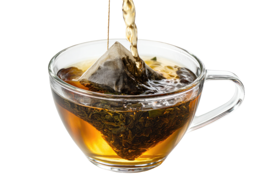 Tea bag steeping in a clear cup.  Hot liquid pouring over a tea bag in a transparent teacup,  creating a gentle splash
