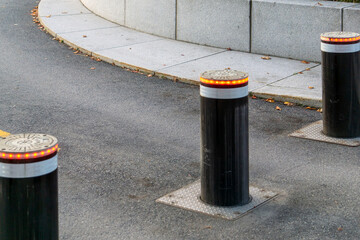 Modern Retractable Security Bollards on Urban Sidewalk at Building Entrance