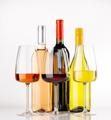 Naklejka premium Different wine bottles and glasses on white background