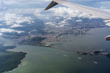 View from the airplane window.Below is Panama City and the Panama Canal. Airplane wing
