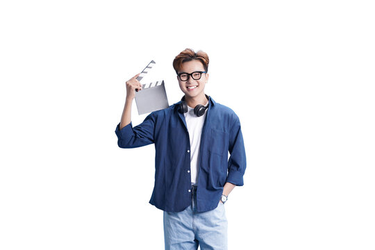 The Smiling Filmmaker : A young, confident filmmaker stands ready on set, holding a clapboard and headphones. Capturing the spirit of movie magic, ready for action!