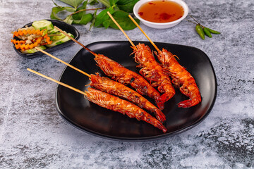 Grilled prawn skewer served sauce