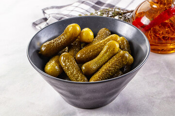 Marinated canned green cornichon cucumbers