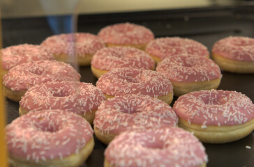 Delicious Strawberry glazed donuts with chocolate flakes at a supermarket