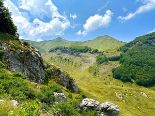 Mountain valley landscape under bright summer sky