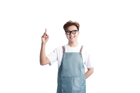 Young Professional in Apron: A friendly, young individual in an apron, showcasing a warm smile and pointing upwards, with glasses. Portraying a casual and welcoming aesthetic.