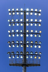 Photograph of numerous floodlight heads in the top section of a large lighting system at a sports stadium arena in Sydney in NSW, Australia.