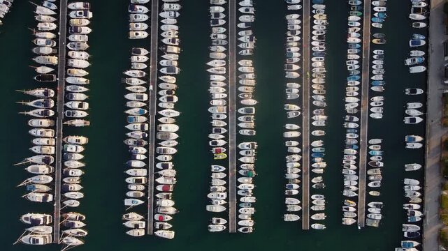 Abstract aerial view of boats moored in the historic port of Koper, Slovenia. Top-down view of the vessels neatly arranged in the water