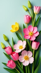 Fototapeta premium A bouquet of pink and yellow flowers arranged on a blue surface, perfect for decoration or gift wrapping