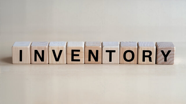 Wooden blocks spelling inventory on a light wood surface ideal for business finance and supply chain management content showcasing organization and stock control for retail and ecommerce