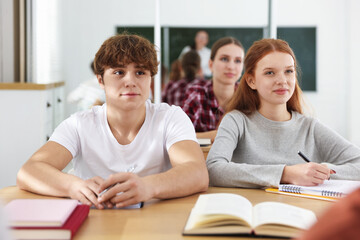 Fototapeta premium Teacher and students during lesson in classroom, selective focus
