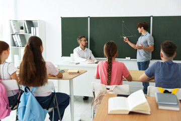 Teacher and students during lesson in classroom