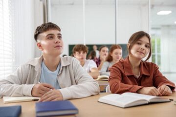Teacher and students during lesson in classroom, selective focus