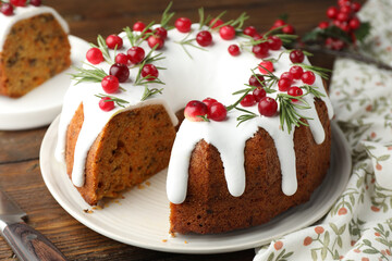 Tasty Christmas cake with cranberries on wooden table, closeup