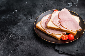 Ham sandwich, toast with sliced Prosciutto Cotto. black background. top view © Mironov