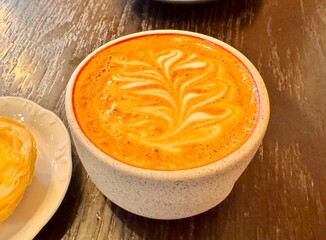 A delicious cappuccino is on the dessert table in the coffee shop. High quality photo