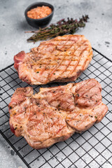 Grilled pork neck steaks, fillet meat. grey background. top view