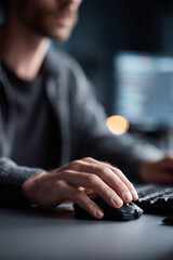 Focused worker using a computer mouse. Concept of coding, design, gaming, or remote work. Perfect for tech, business, or lifestyle content.