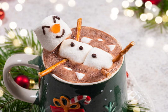 Fun holiday hot chocolate with marshmallow snowman enjoyed by the cozy fire