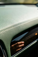 Interior view of automotive service focus on dashboard material and craftsmanship details during daylight hours