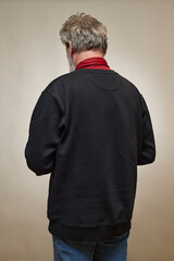 Old man over 60 portrait in studio with smartphone