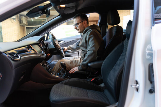 Young man entering new car ready starting journey