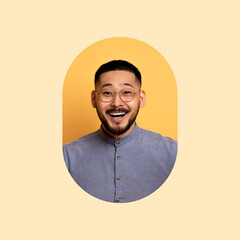 A man with short hair and glasses smiles widely against a warm, light background. He appears happy and engaged, showcasing a cheerful personality in this vibrant setting.