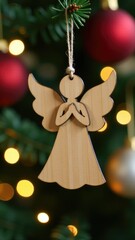 Obraz premium A wooden angel hangs from a decorated Christmas tree, perfect for holiday decorations and celebrations