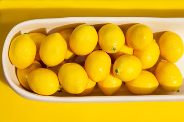 New York City, NY, USA. Bowl full of bright yellow lemons on display