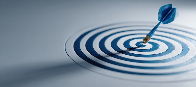 Blue Dart Hitting Bullseye on White Surface Symbolizing Precision and Success