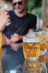 Cold Beer Mug with Reflection on Outdoor Table