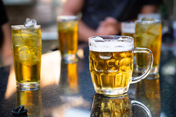 Cold Beer Mug with Reflection on Outdoor Table