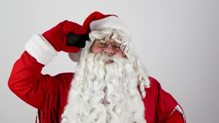 Santa Claus is taking a Christmas selfie with his smartphone