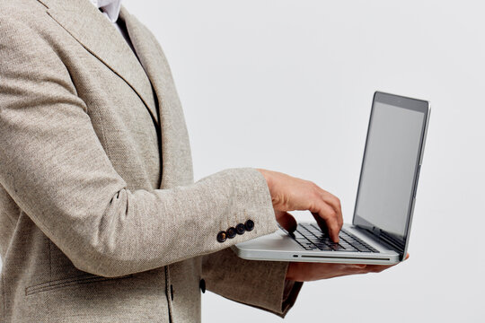 man holding laptop typing work freelance business casual suit digital nomad remote office concept technology