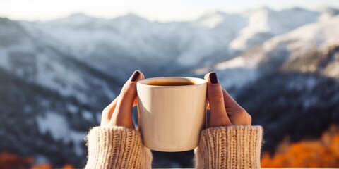 A girl holds a mug of hot drink, coffee, tea against the background of winter mountains in the camp. Generative AI.