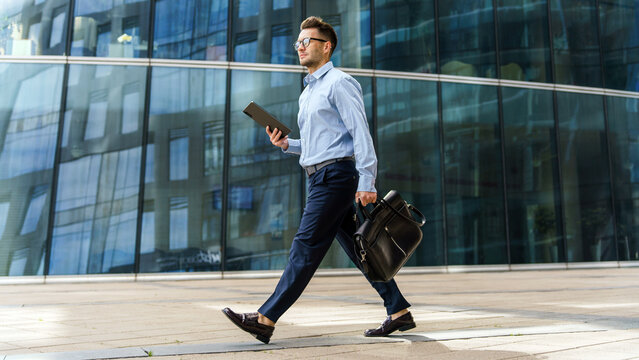 Businessman walking confidently in a modern urban setting