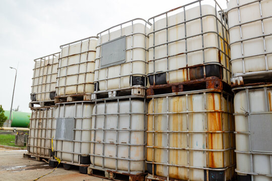 Stack of Industrial Intermediate Bulk Containers (IBCs) with Metal Cages and Pallets