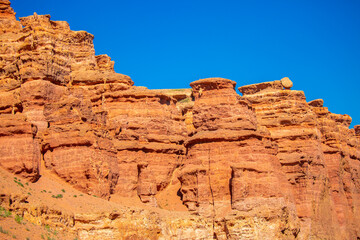 Fototapeta premium Charyn Canyon, Valley of Castles. The excellence of Kazakhstan. Panorama of natural unusual landscape. The red canyon of extraordinary beauty looks like a Martian landscape.