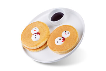 Pancakes with marshmallow snowmen in a plate for Christmas holidays on a white isolated background